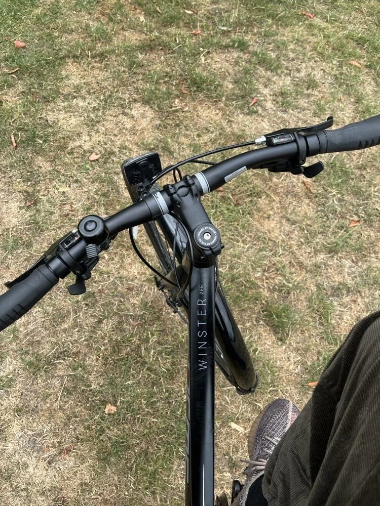 Ibukun's bike handlebars on the grass